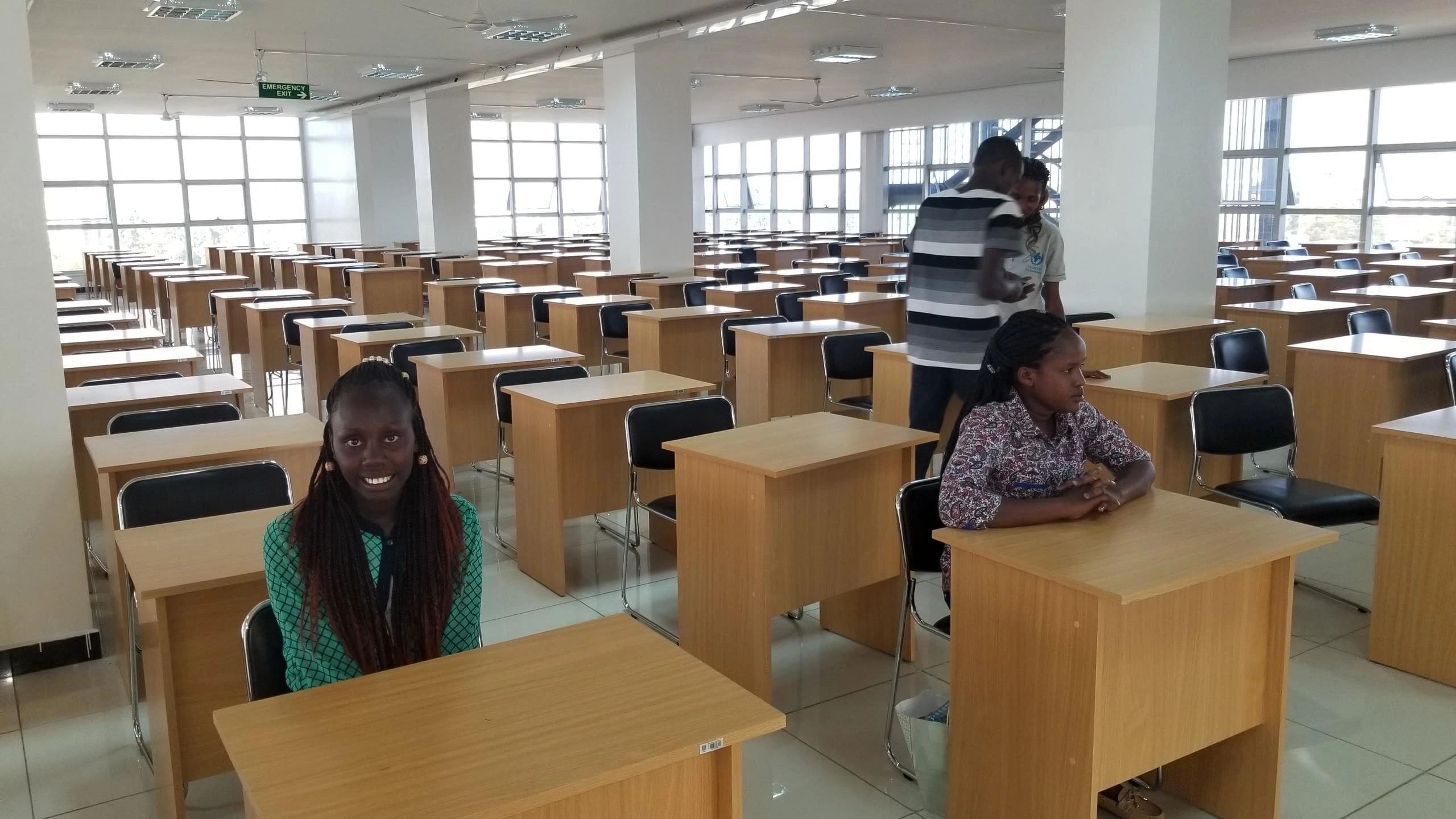 Students sitting at desks in a spacious, bright classroom.