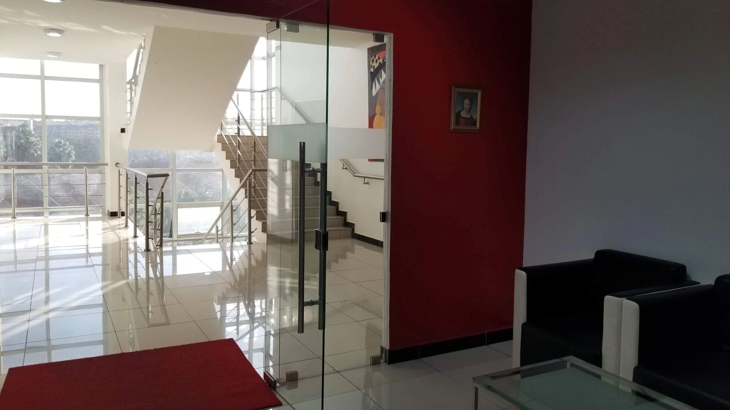 Modern interior with glass door and staircase.