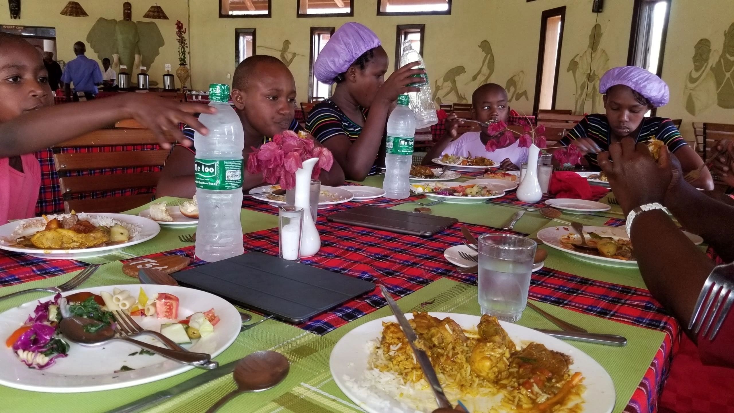 Children enjoying a meal together at a dining table.