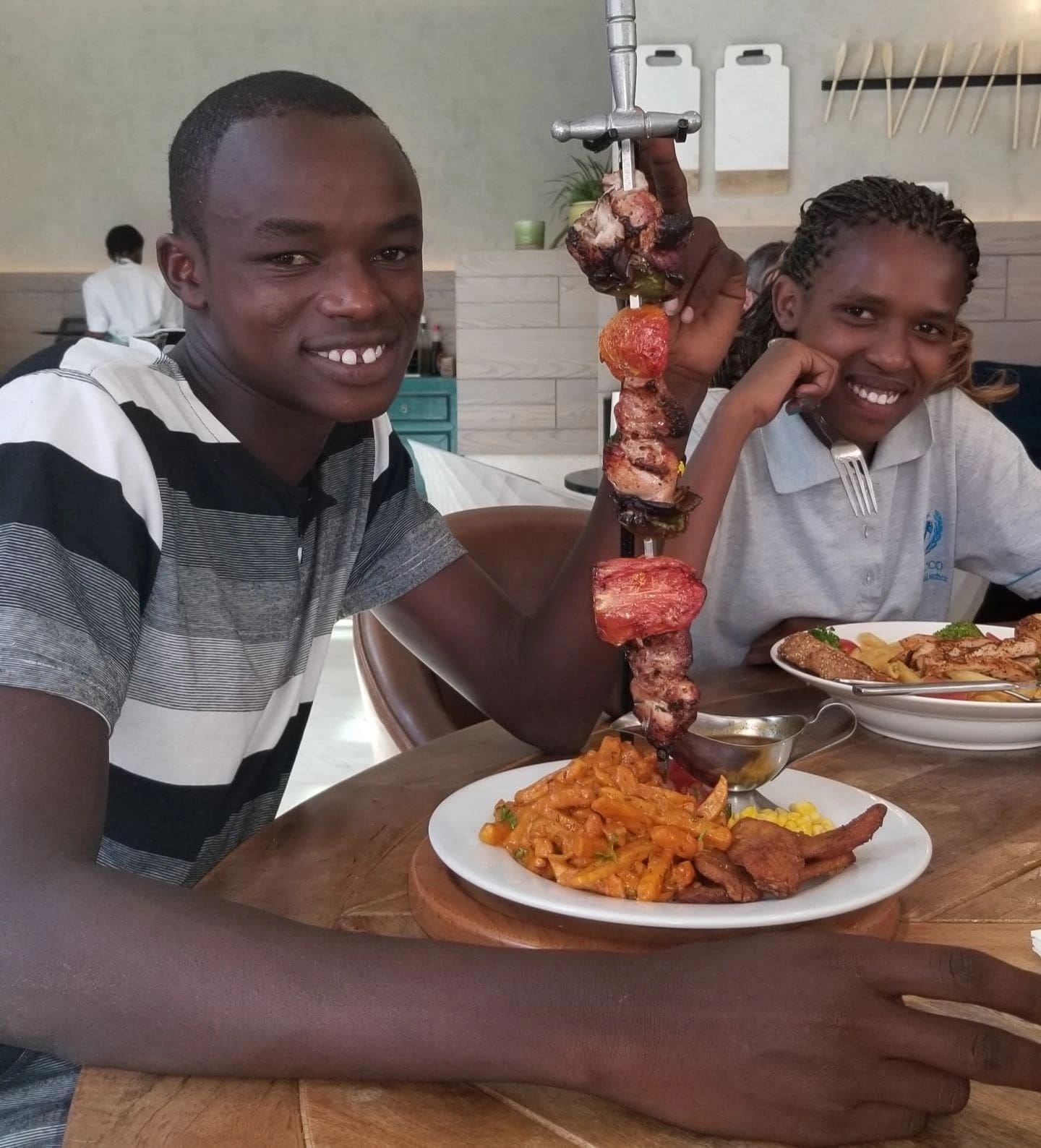 Two men enjoying a meal together at a table.