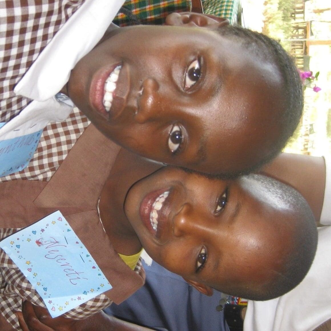 Two smiling children posing for a close-up photo.