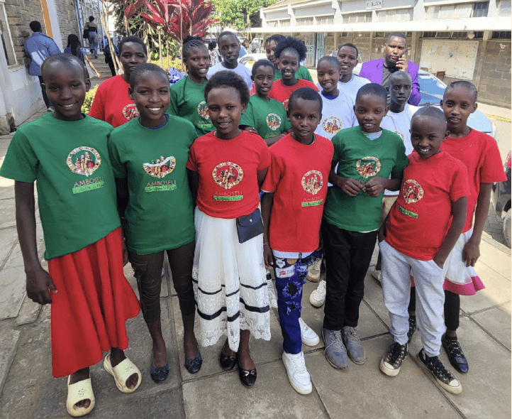 Smiling children wearing red and green shirts