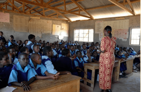 Teacher addressing crowded classroom of students